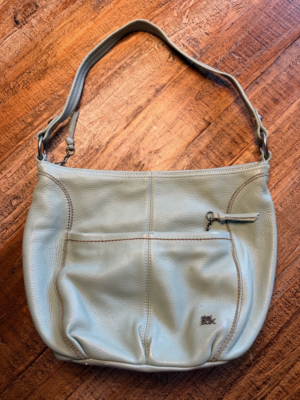 The Sak hobo bag in a light blue/green color used but great condition leather